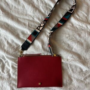 Chic Red Crossbody Bag with Textured Leather and Colorful Strap